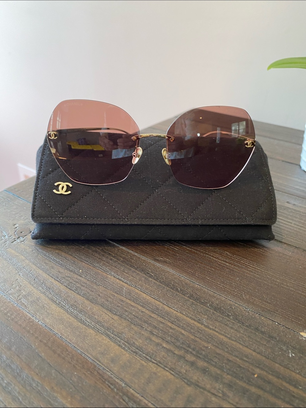 CHANEL Authentic Rimless Sunglasses with Brown Gradient Lenses and Gold Accents.